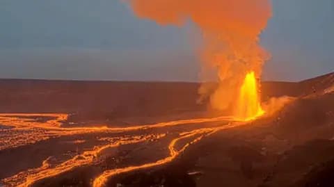 Lava flows down a volcano from the summit