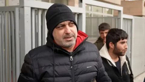 Man in black beanie and black puffer 