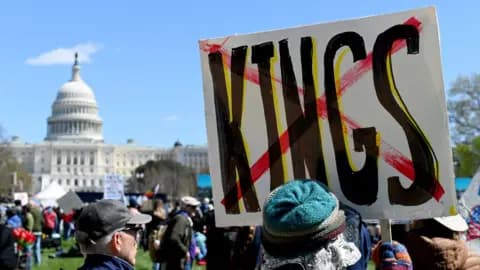 People holding signs gather at a "No Kings" protest at the National Mall on March 28, 2026 in Washington DC.
