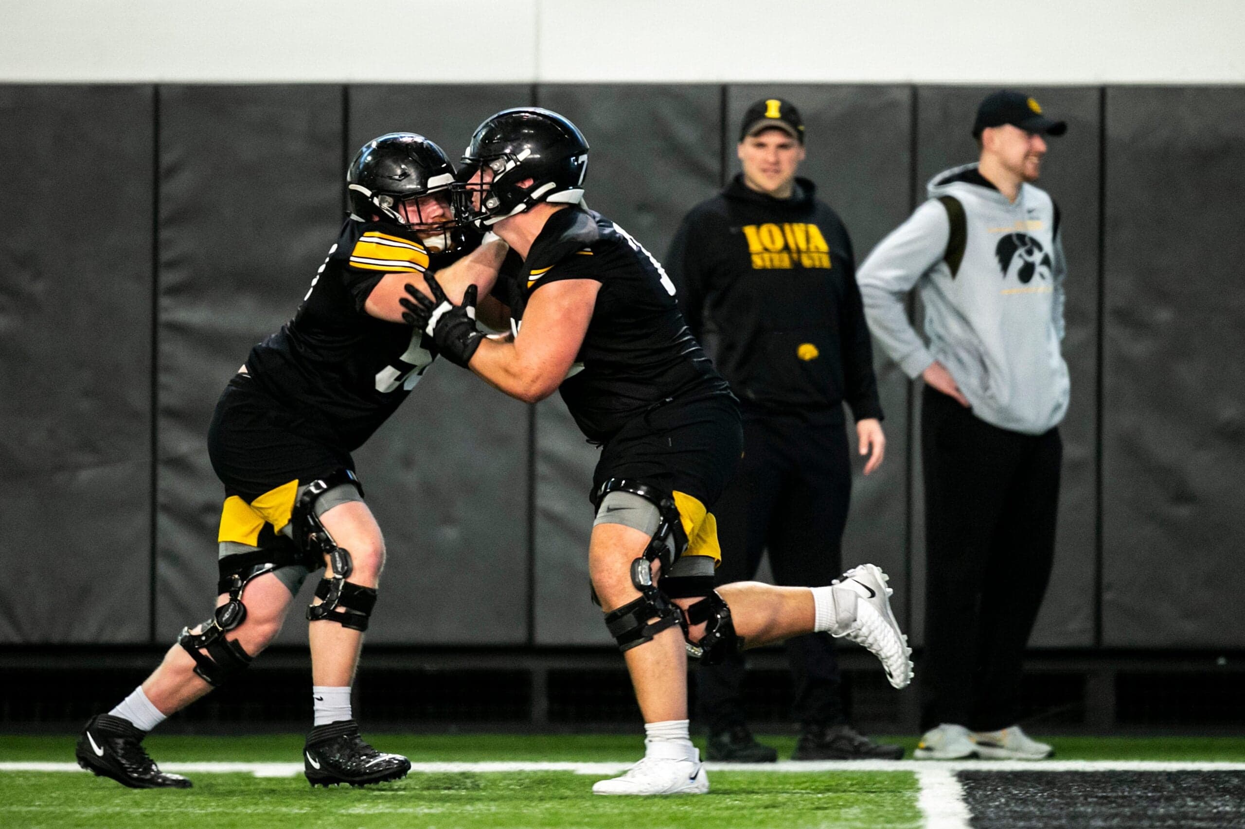 Iowa offensive lineman, left, Griffin Liddle runs a drill with Beau Stephens during a spring NCAA football practice, Thursday, March 30, 2023, at the University of Iowa Indoor Practice Facility in Iowa City, Iowa.