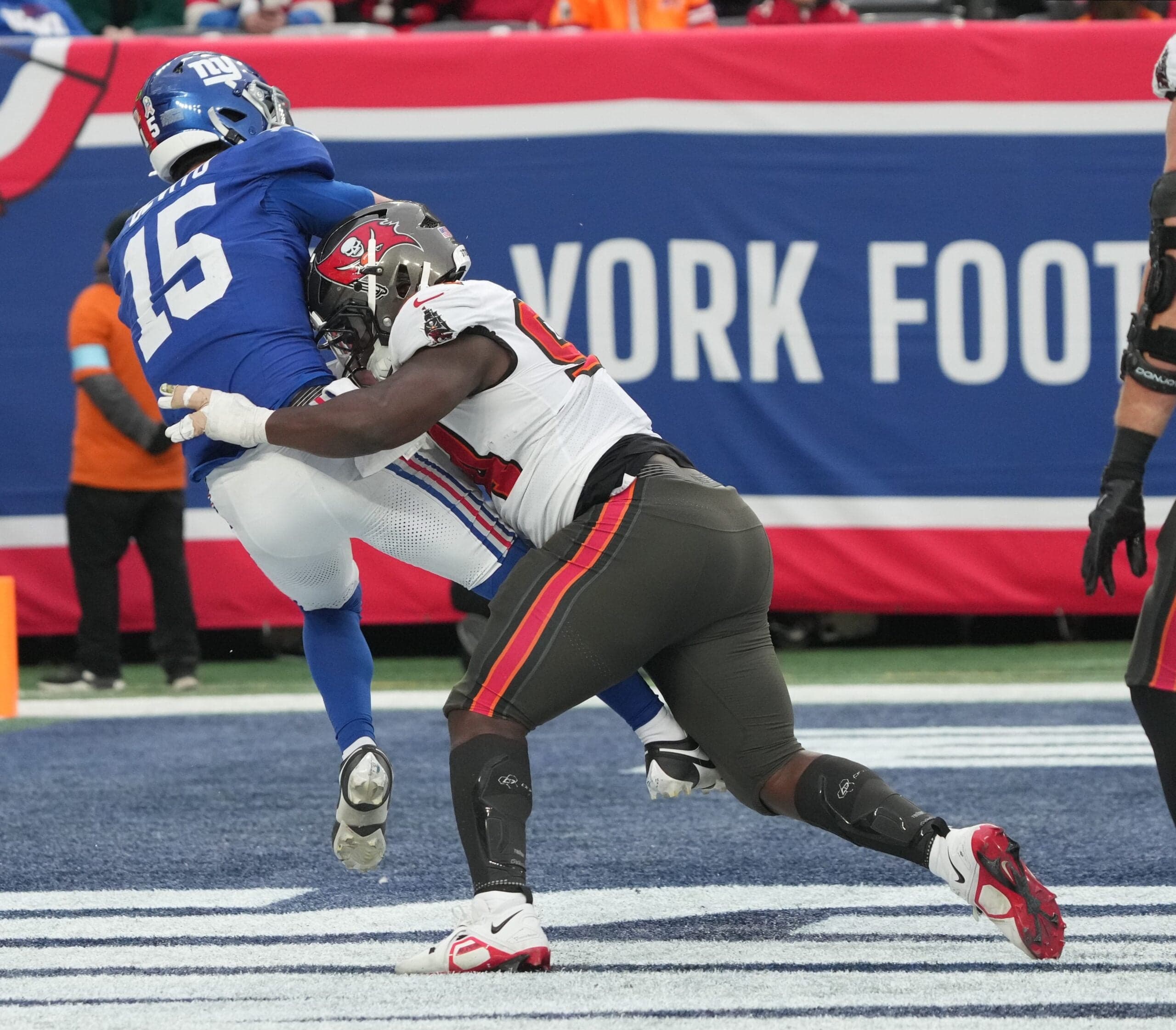East Rutherford, NJ -- November 24, 2024 -- Tommy DeVito of the Giants gets hit after he threw this pass by Calijah Kancey of Tampa Bay in the fourth quarter. DeVito was injured and came out of the game for one play as the Tampa Bay Buccaneers came to MetLife Stadium and defeated the New York Giants 30-7.