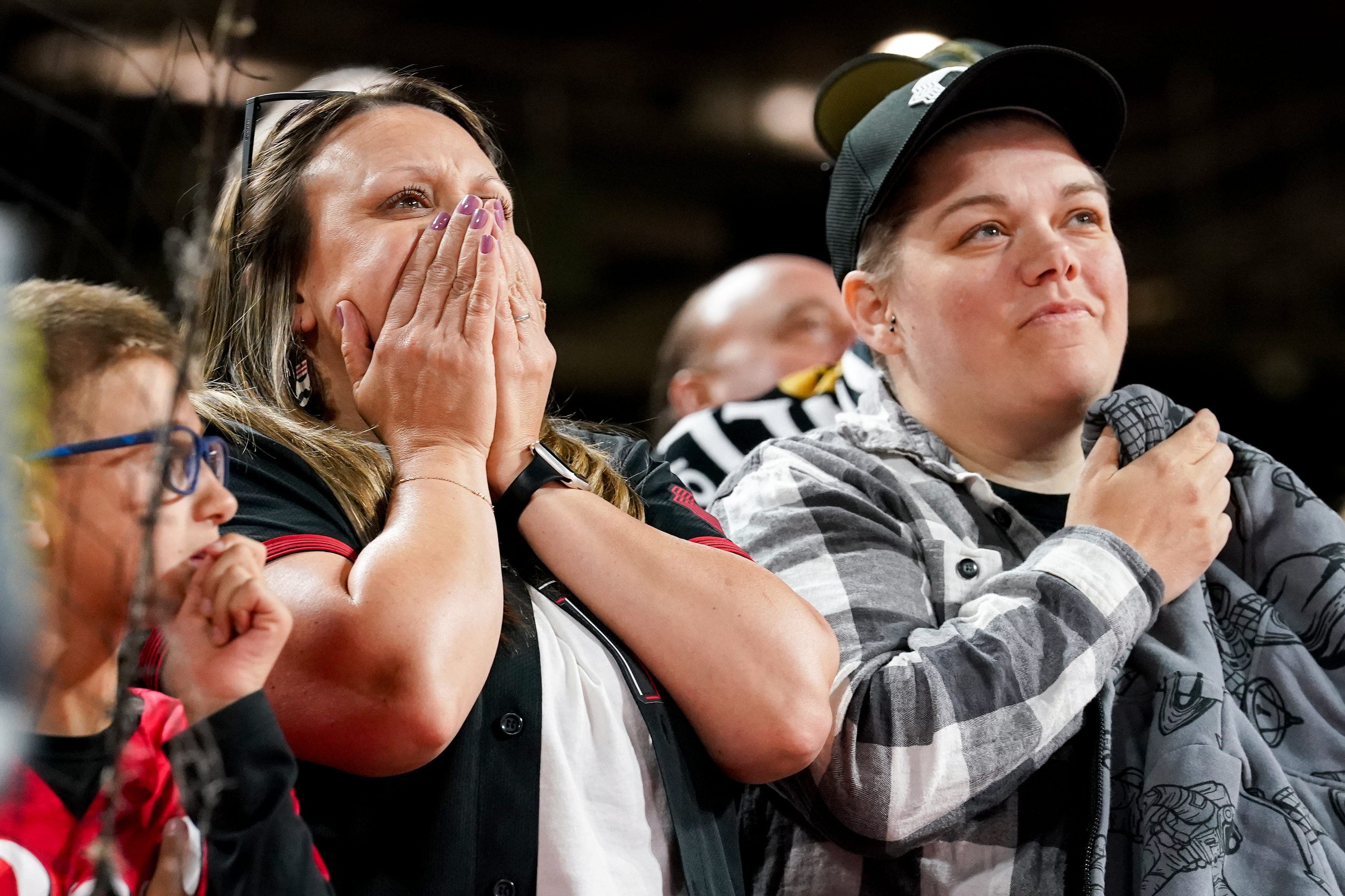 Fans wait for the call on a review of a hit by Cincinnati Reds first baseman Spencer Steer (not pictured) in the 10th inning against the Washington Nationals.