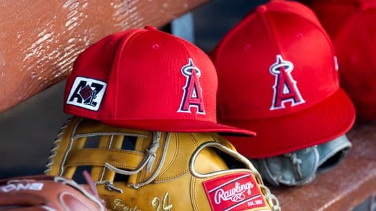 Feb 28, 2025; Phoenix, Arizona, USA; Detailed view of the Los Angeles Angels logo on a hat in the dugout during a spring training game at Camelback Ranch-Glendale.