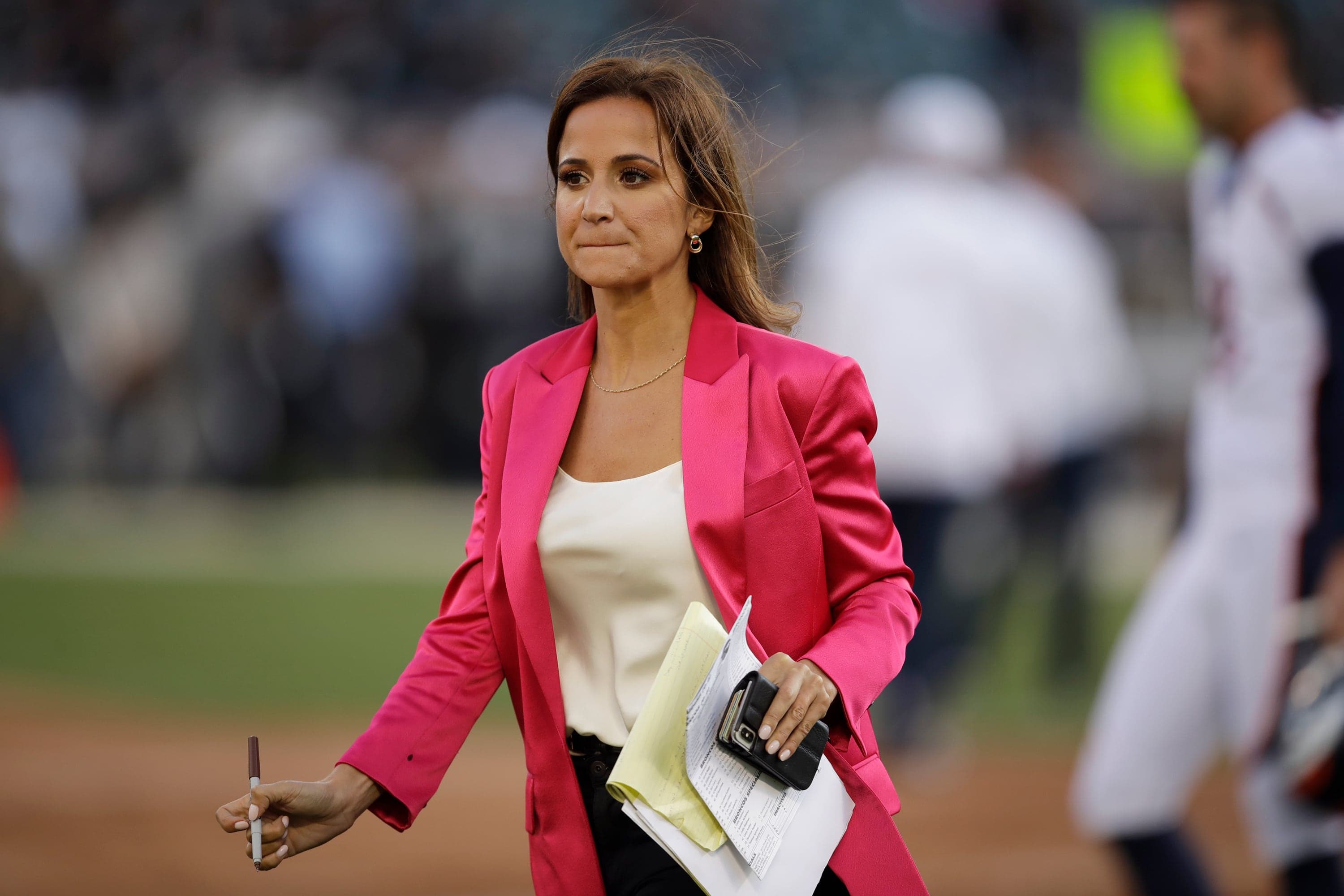 FILE- Reporter Dianna Russini works on the sidelines before the start of an NFL football game between the Oakland Raiders and the Denver Broncos Monday, Sept. 9, 2019, in Oakland, Calif. (AP Photo/Ben Margot, File)