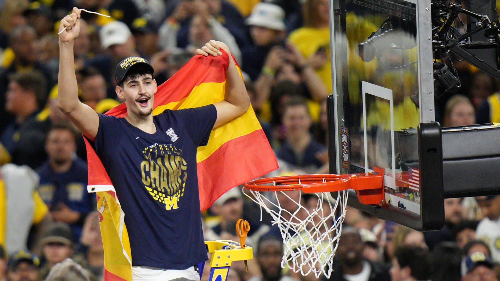 Aday Mara corta la red de la canasta con la bandera de España tras proclamarse campeón de la NCAA
