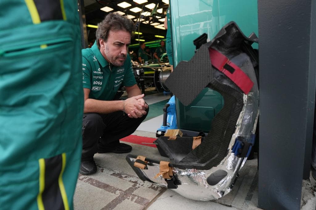 Fernando Alonso, examina su asiento del AMR26, en una carrera de este año.