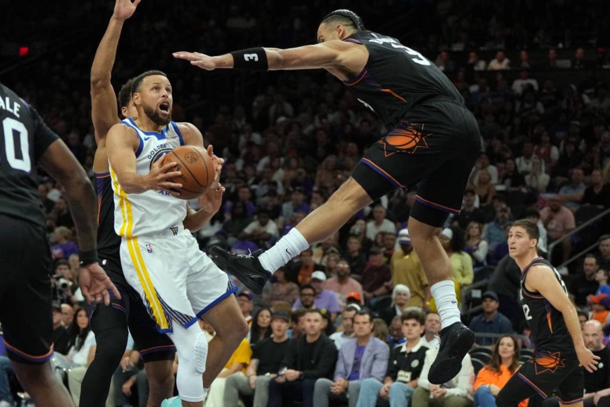 Stephen Curry, acosado por la defensa de Dillon Brooks.