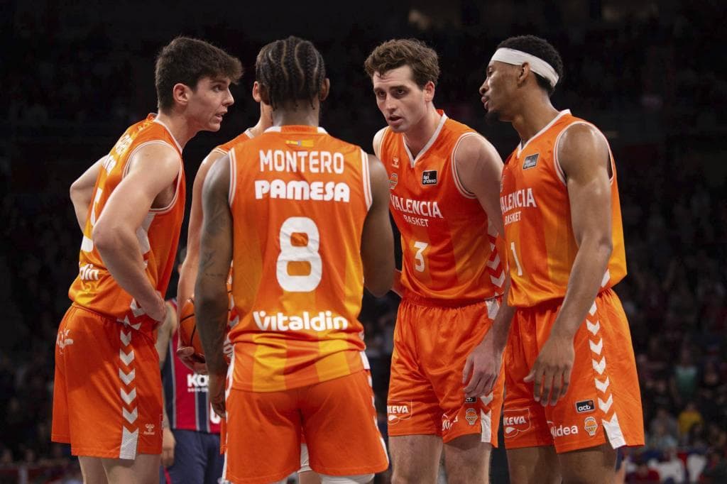 Un quinteto de jugadores del Valencia Basket charlan durante un encuentro.
