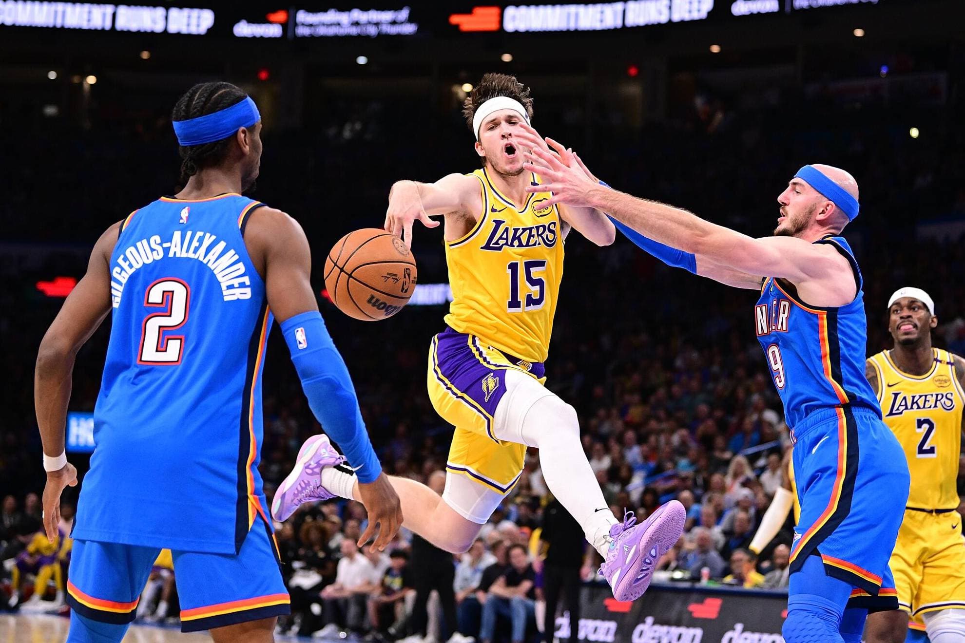 Austin Reaves entra a canasta entre Shai Gilgeous-Alexander y Alex Caruso.