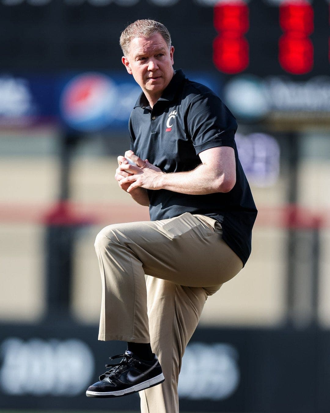 UC hoops coach Calhoun throws opening pitch, Bearcats beat Xavier