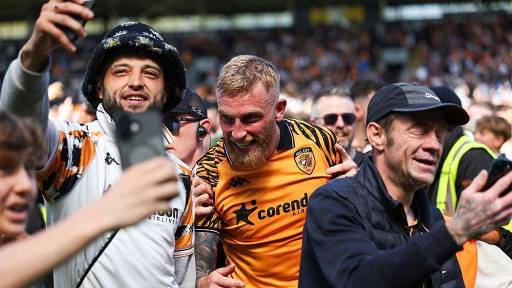Hull City fans celebrate reaching the play-offs with match-winner Ollie McBurnie