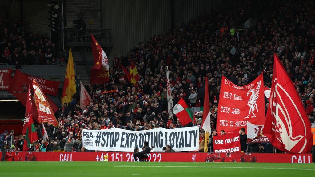 Liverpool hold a banner reading 'Stop exploiting loyalty' on the Kop before kick-off in a Premier League match