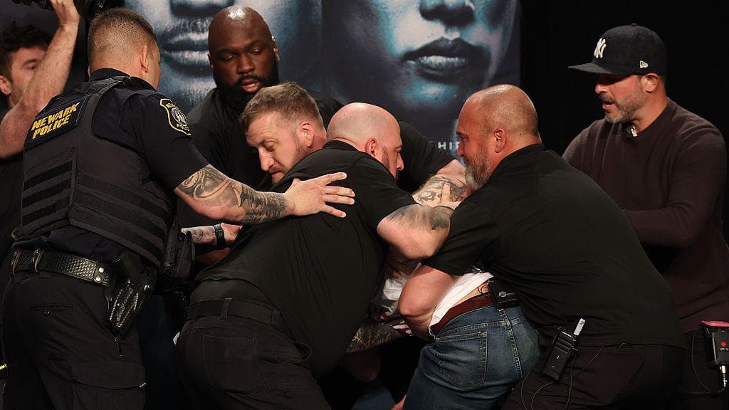 Security and armed police step in to separate Sean Strickland and Khamzat Chimaev at the UFC 328 news conference