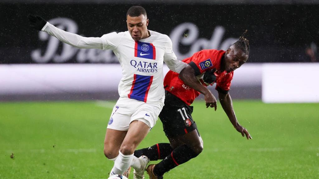 PSG's Kylian Mbappe and Rennes' Jeremy Doku battle for possession in 2023