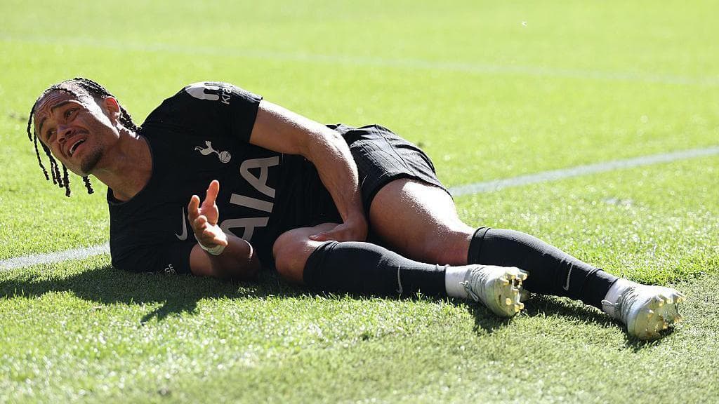 Xavi Simons on the ground, clutching his right leg