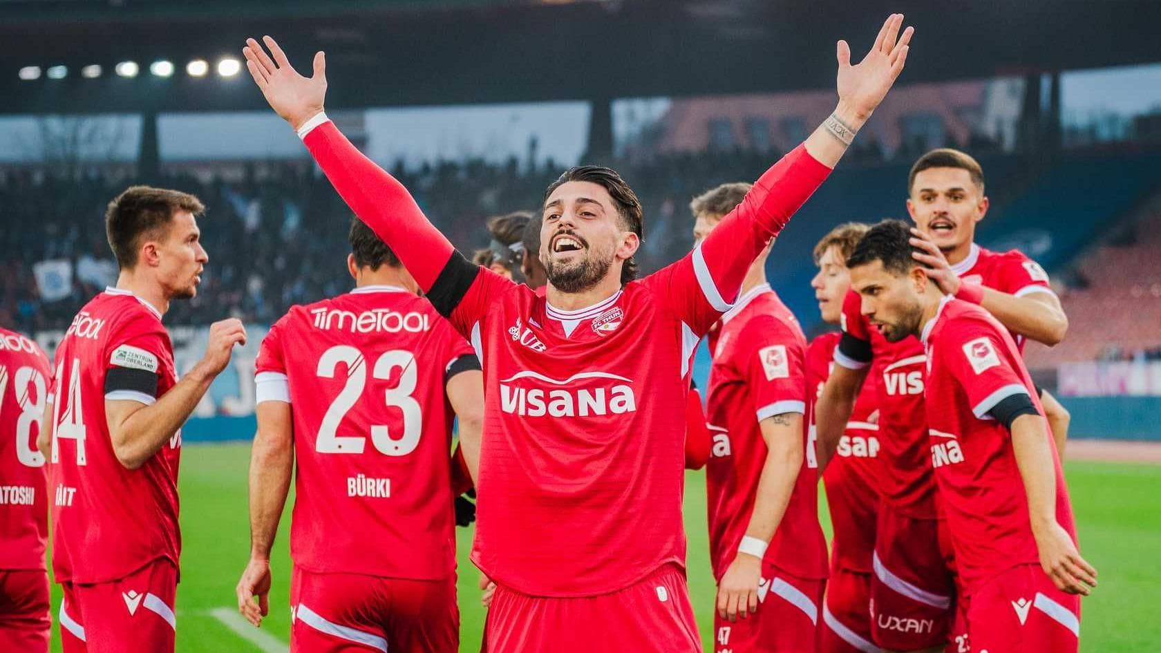 Kastriot Imeri raises his arms in celebration