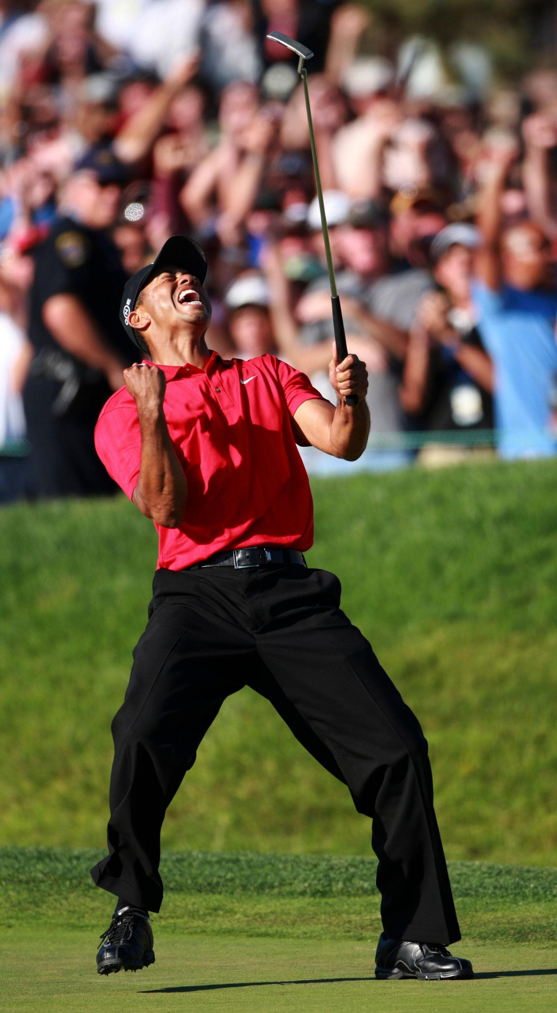 Tiger Woods celebrates after holing a putt on the 18th green to force a play-off against Rocco Mediate at the 2008 US Open that he would go on to win