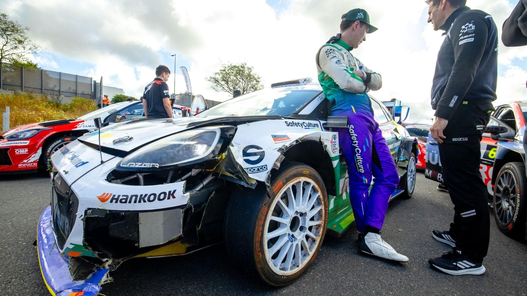 Jon Armstrong of Ireland leans on his damaged M-Sport Ford Puma during service at Rally Islas Canarias