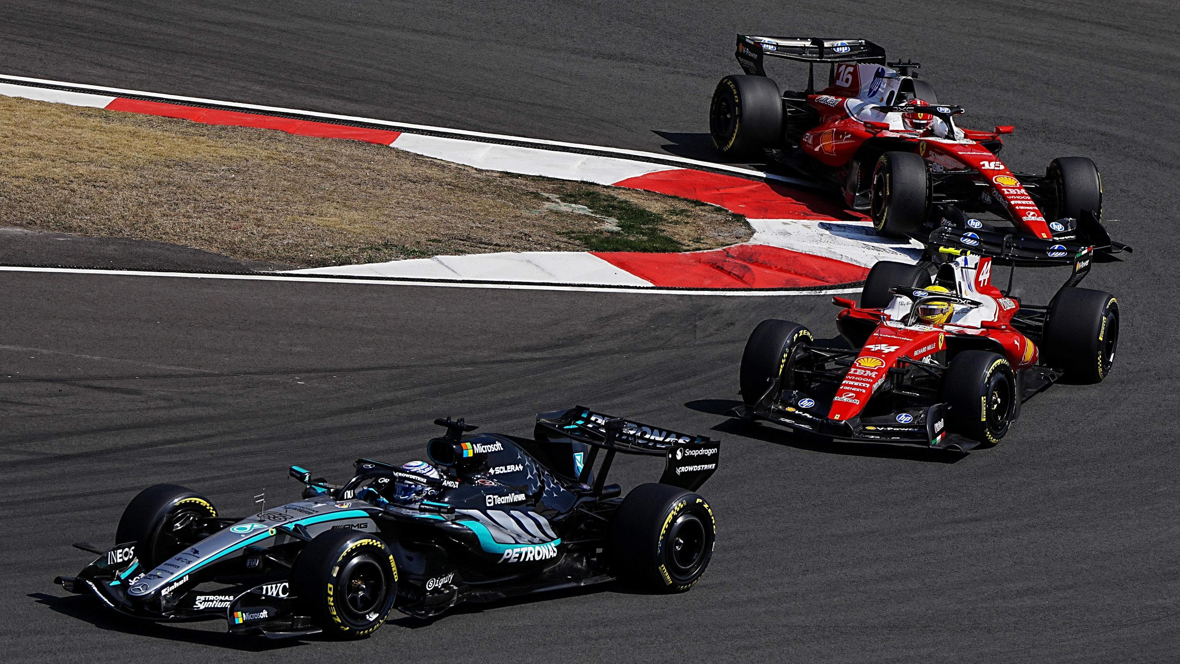 Mercedes' George Russell comes out of a hairpin ahead of Ferrari's Lewis Hamilton with Charles Leclerc immediately behind during the Chinese Grand Prix sprint race