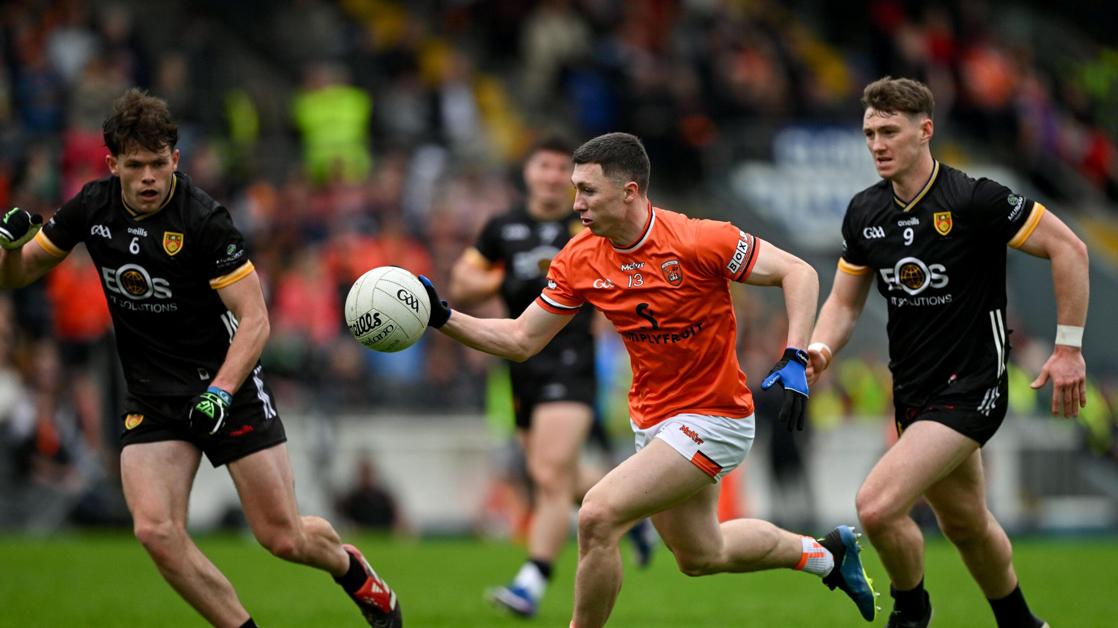 Oisin Conaty runs with the ball