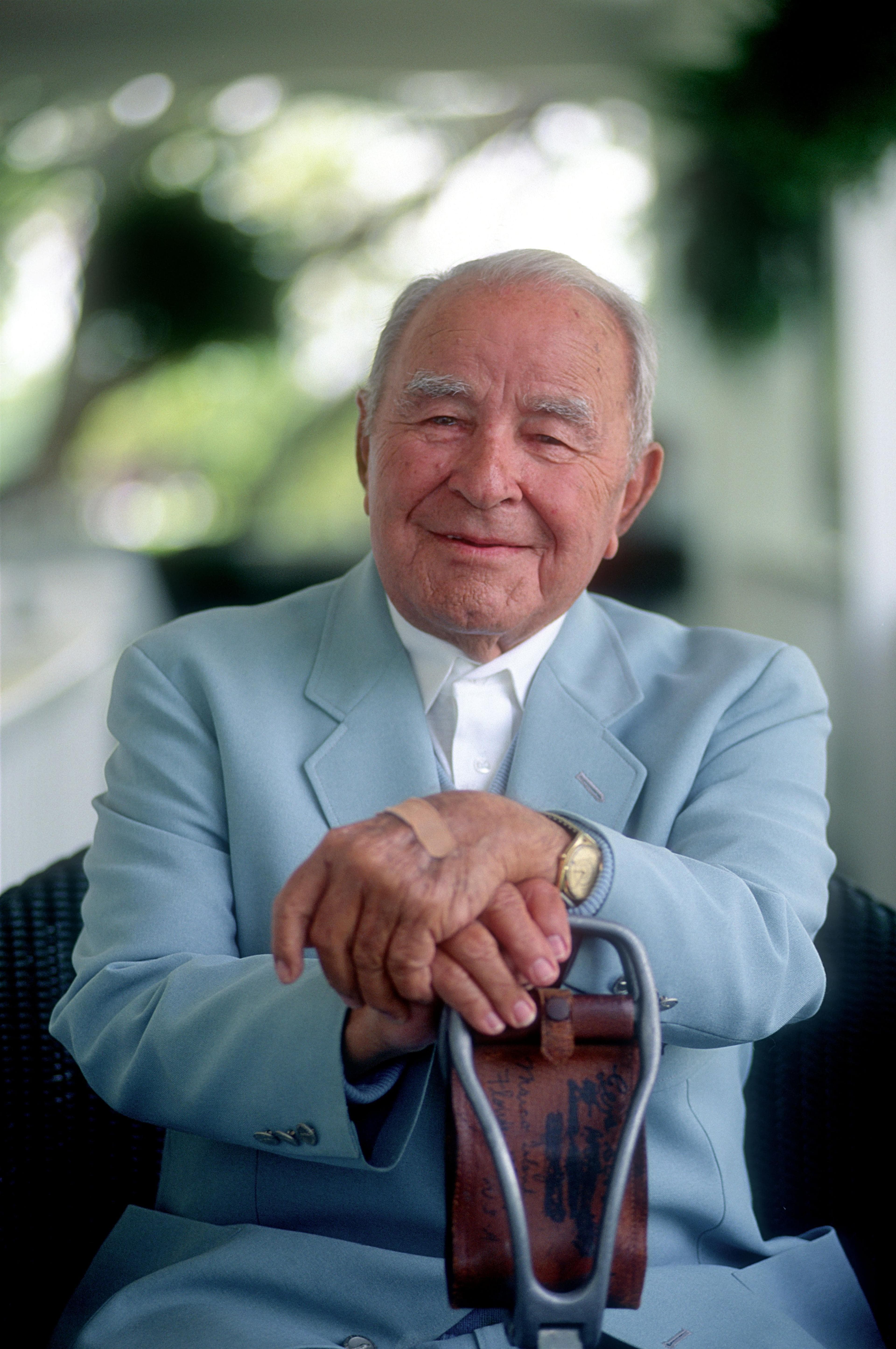Gene Sarazen sitting on a balcony at the Augusta National clubhouse in 1994