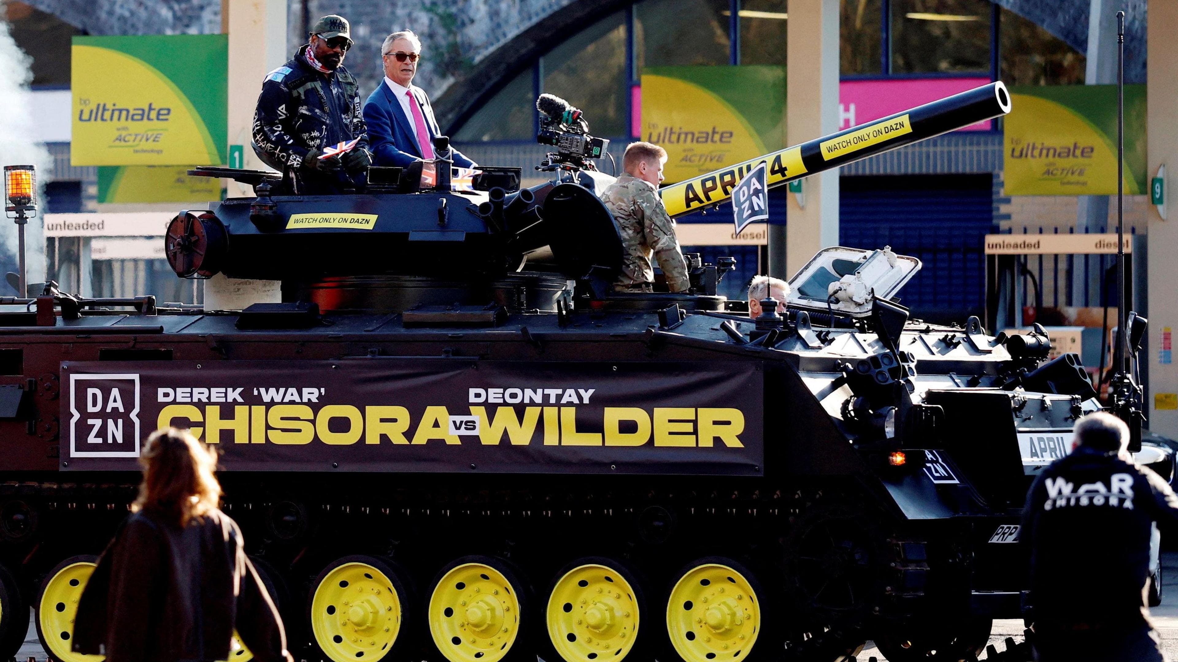 Derek Chisora and Nigel Farage on a tank