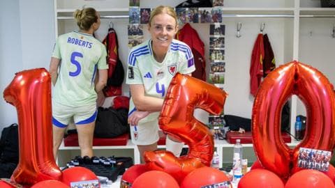 Sophie Ingle with numbered balloons spelling out 150 in the Wales dressing room in Albania