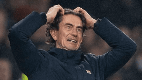 Thomas Frank with his hands on his head