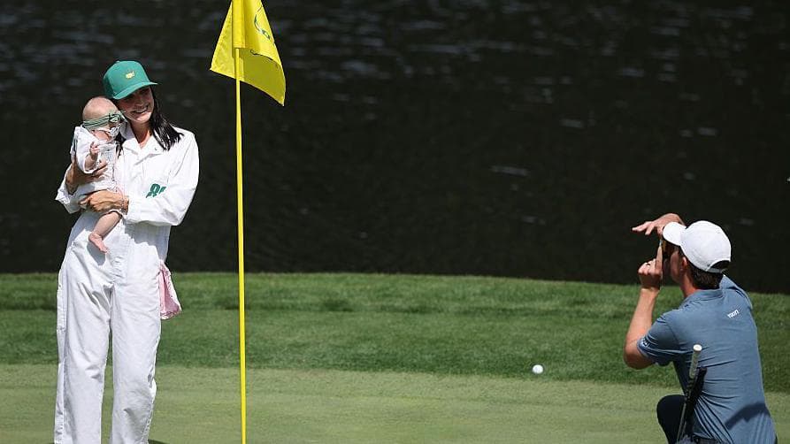 Maverick McNealy takes a photo of his wife and child
