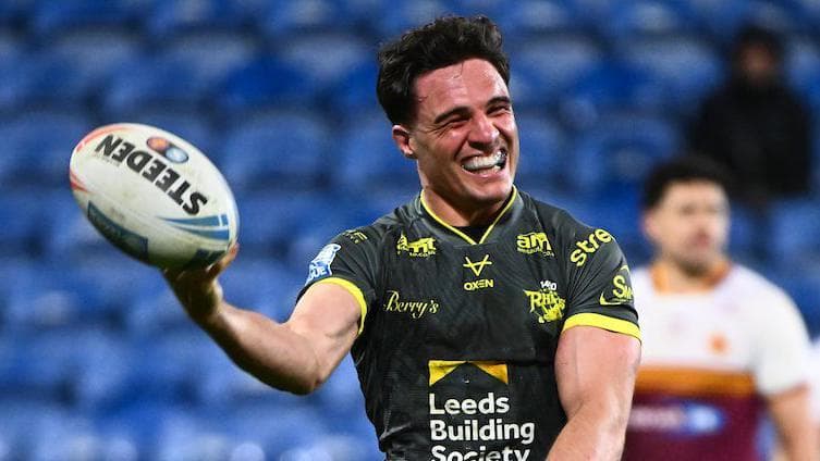 Leeds run riot at Huddersfield to go top