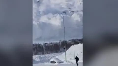 A wall of snow seen descending on cars and roads in Russia.