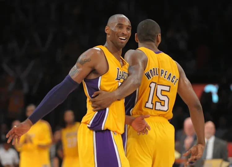 Nov 20, 2012; Los Angeles, CA, USA; Los Angeles Lakers guard Kobe Bryant (24) and forward Metta World Peace (15) react in the fourth quarter against the Brooklyn Nets at the Staples Center. The Lakers defeated the Nets 95-90. Mandatory Credit: Kirby Lee/Image of Sport-Imagn Images