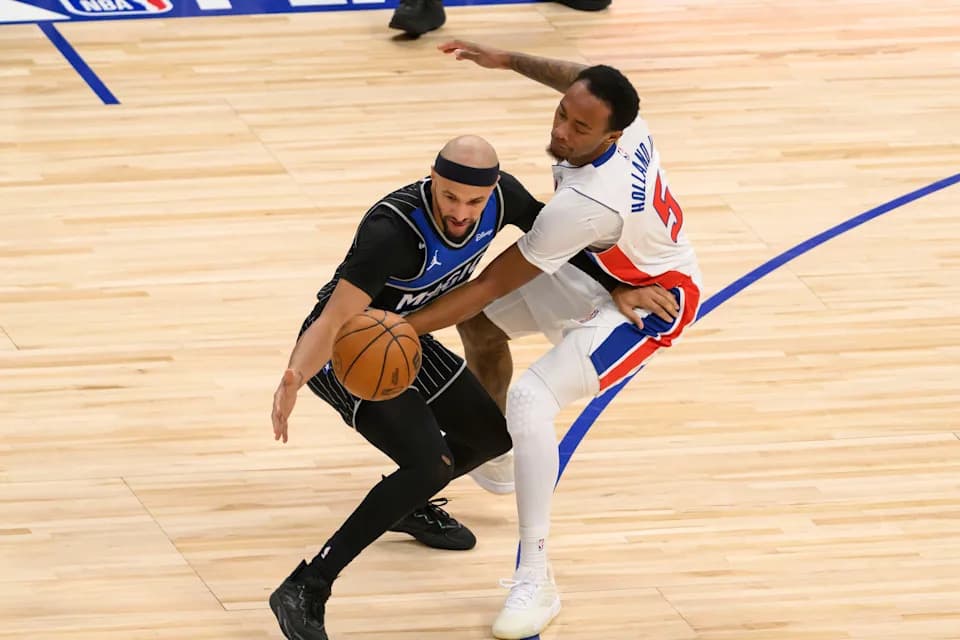Detroit forward Ronald Holland II tries to steal the ball away from Orlando guard Jalen Suggs during the second quarter of game two of an NBA semifinals game a game between the Detroit Pistons and the Orlando magic at Little Caesars Arena, in Detroit, April 22, 2026.